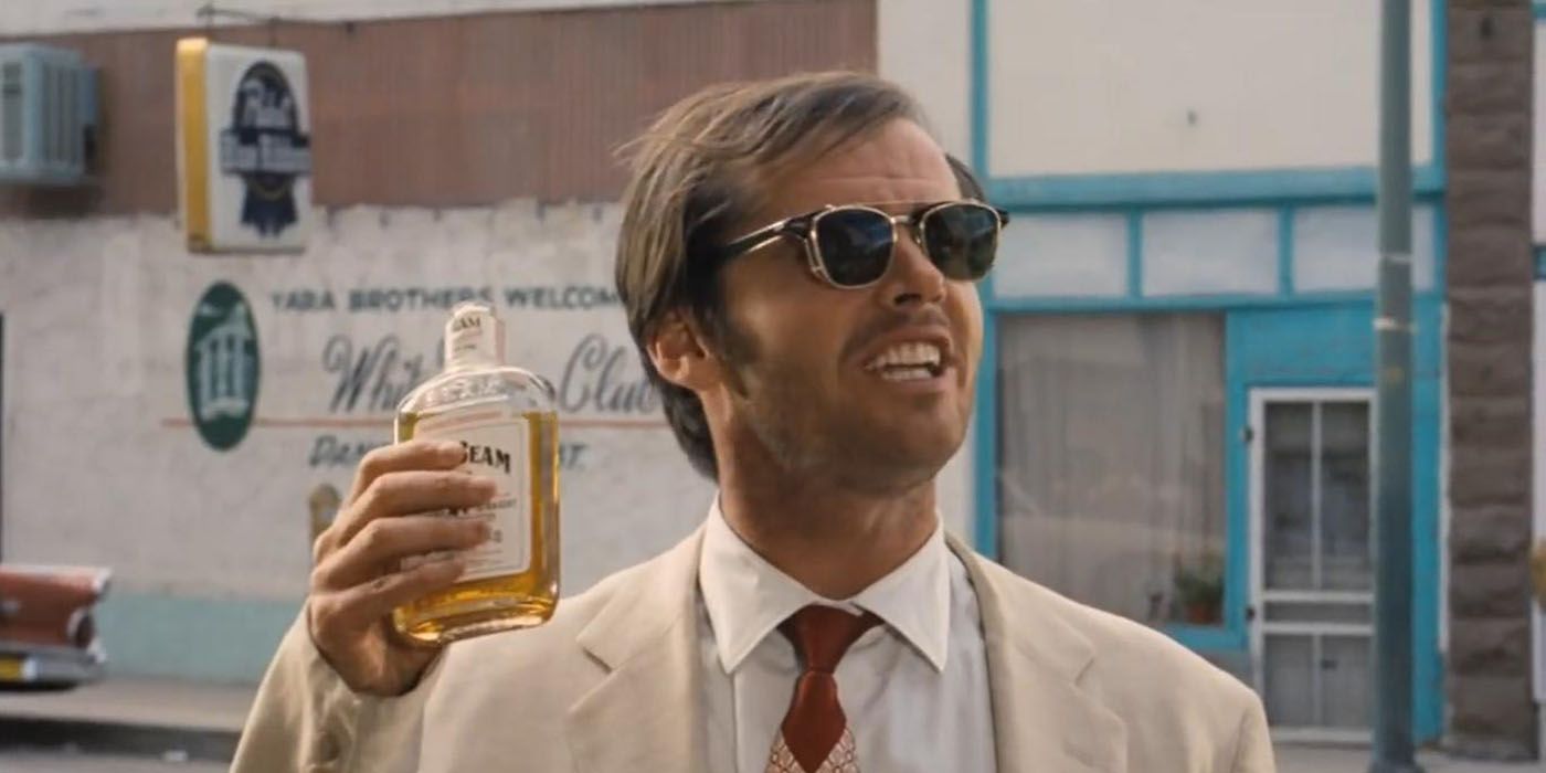 Jack Nicholson holds up a bottle in Easy Rider