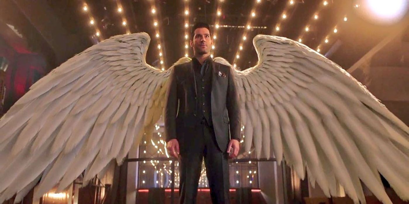 Lucifer standing, his large white wings sprawled behind him.