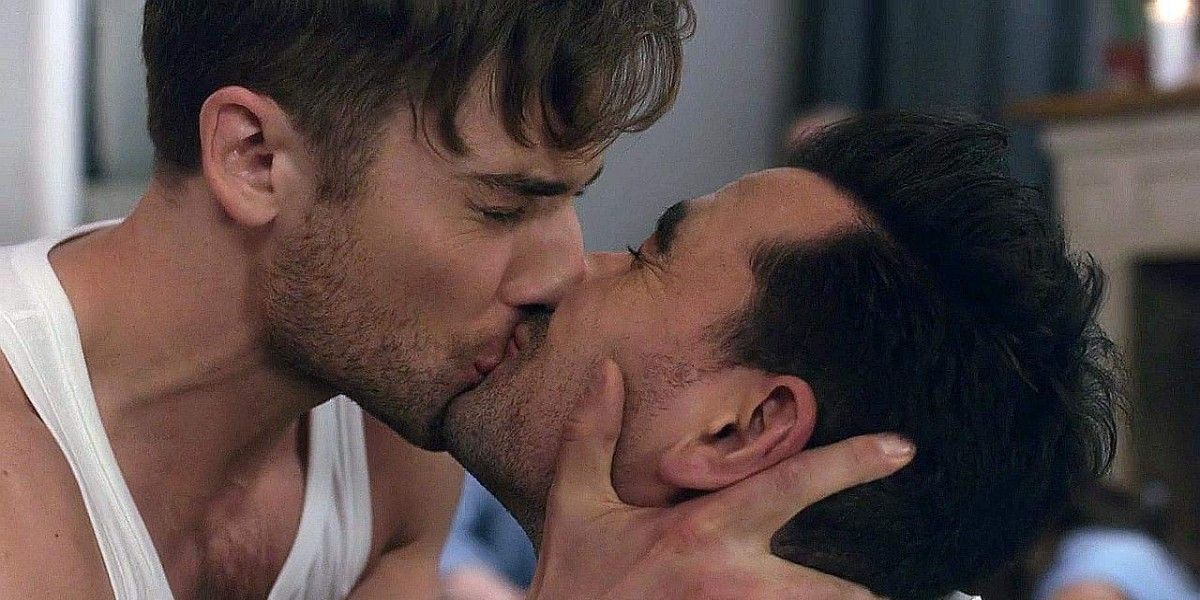 David and Ted kiss during a game of spin the bottle in Schitt's Creek