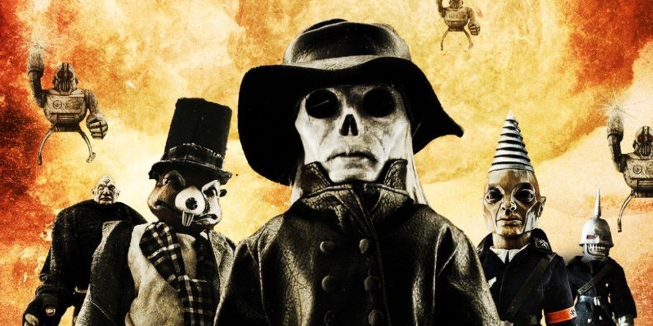 Puppets standing with flames behind them