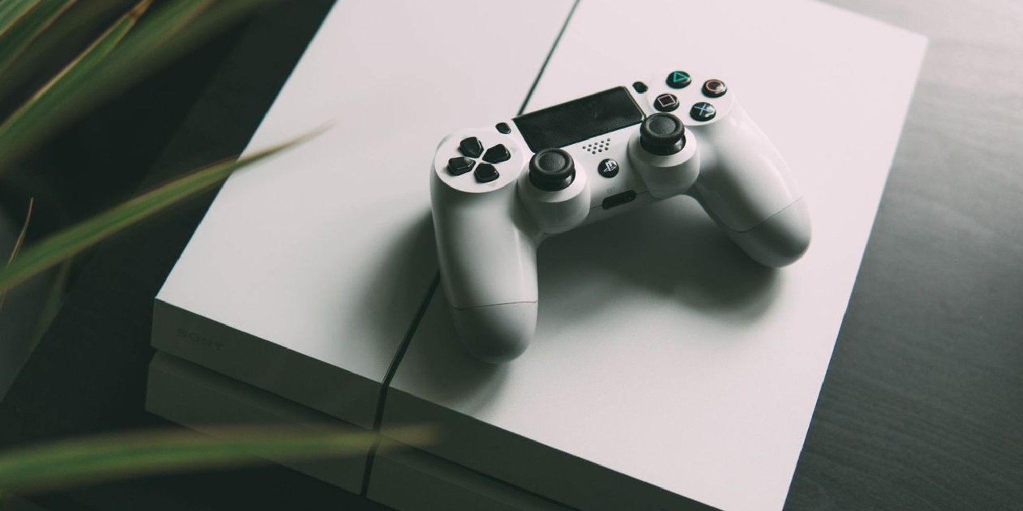 A white PS4 with matching controller 