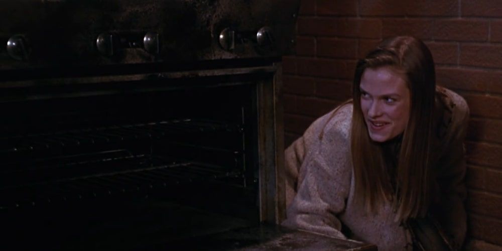 Allison hiding behind an oven in Hocus Pocus