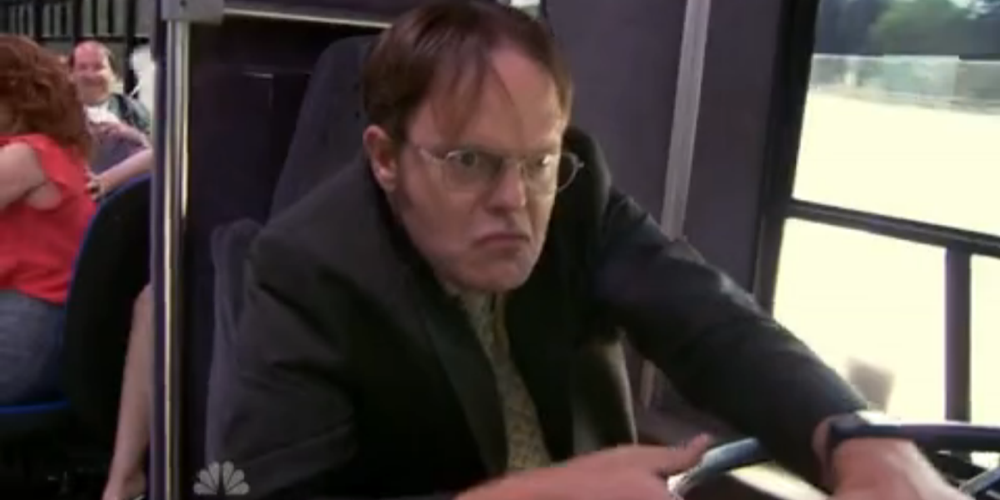 Dwight driving the work bus