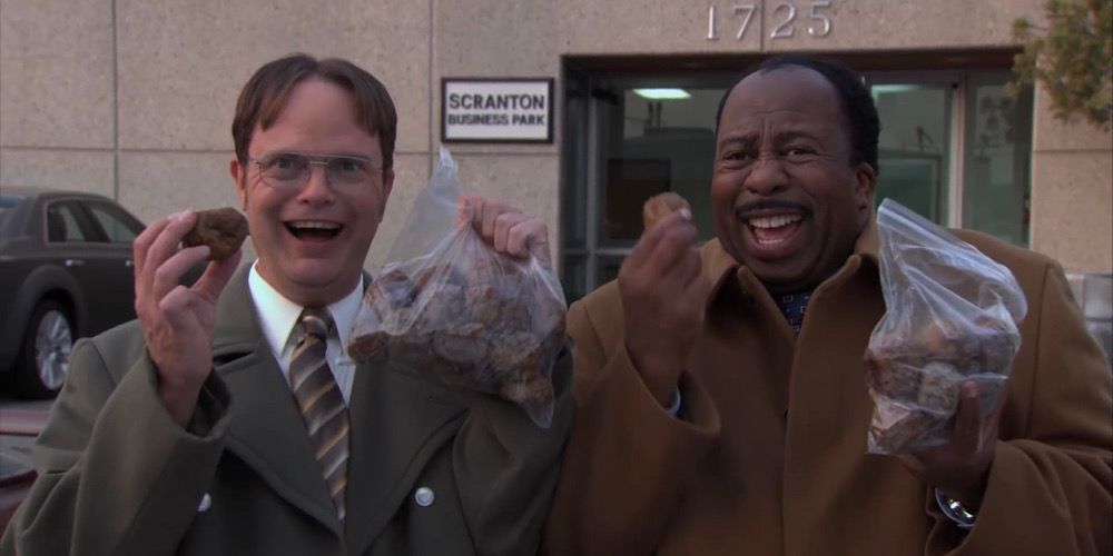 Dwight and Stanley holding meatballs