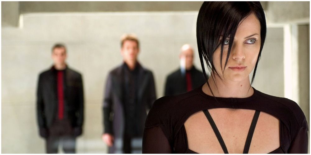 Woman Looking Off Camera With Men Behind Her