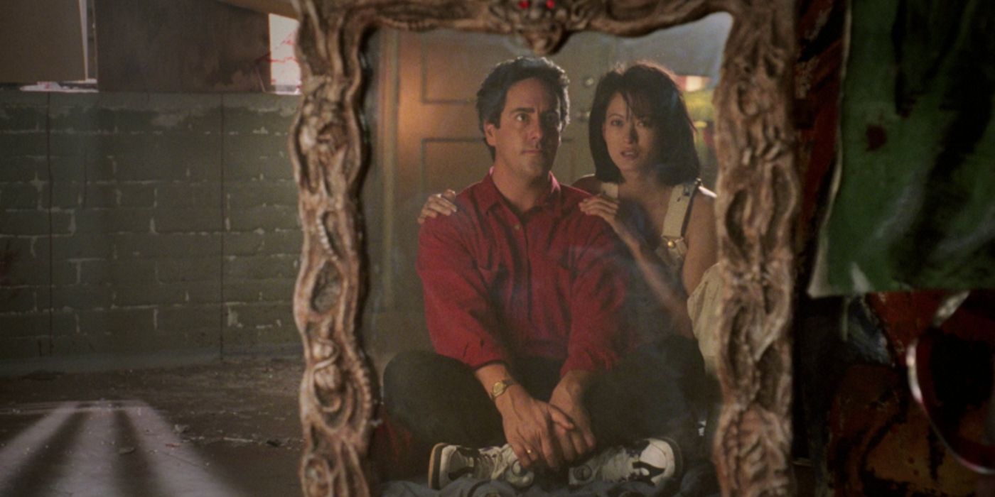 Two people look at themselves in a mirror in Amityville: A New Generation (1993)