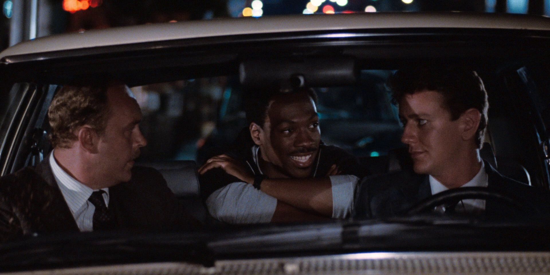 Axel, Rosewood, and Taggart sit inside a car in Beverly Hills Cop