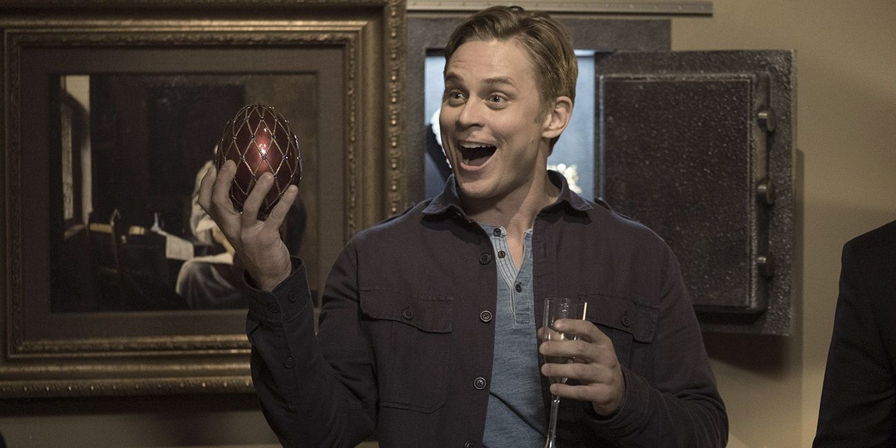 Billy Magnussen holding a faberge egg in Game Night