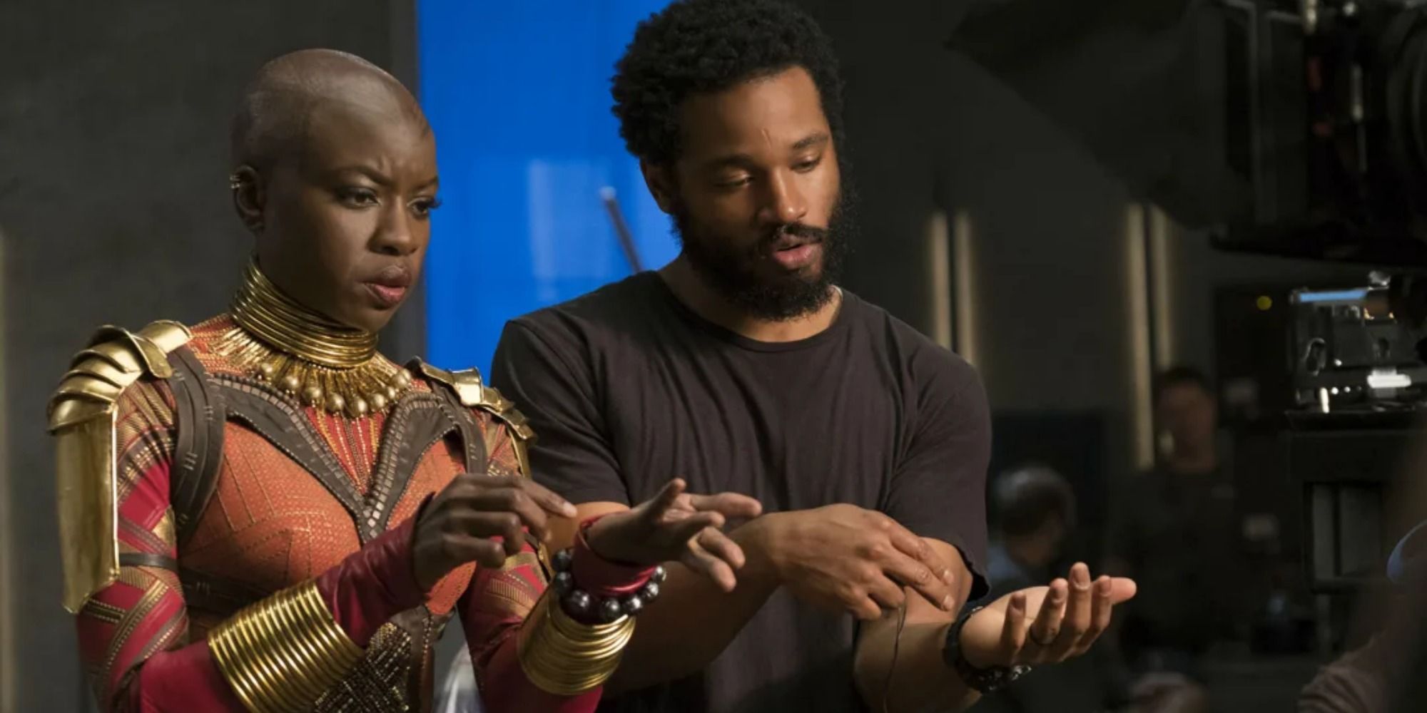 A screenshot behind-the-scenes of director Ryan Coogler showing Danai Gurira her cues as Okoye in Black Panther
