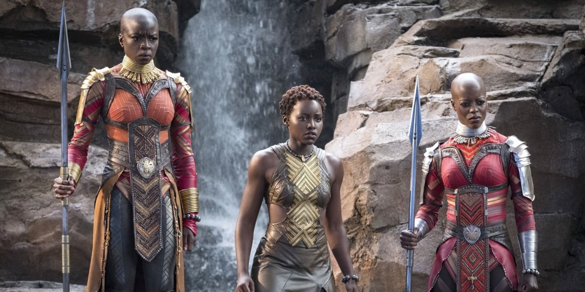 Okoye, Nakia and Ayo underneath a waterfall looking concerned in Black Panther