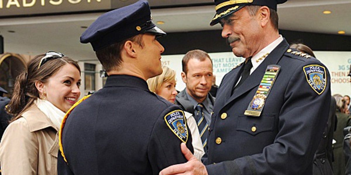 Frank and Jamie, with Danny, Linda and Nicky in the background in Blue Bloods