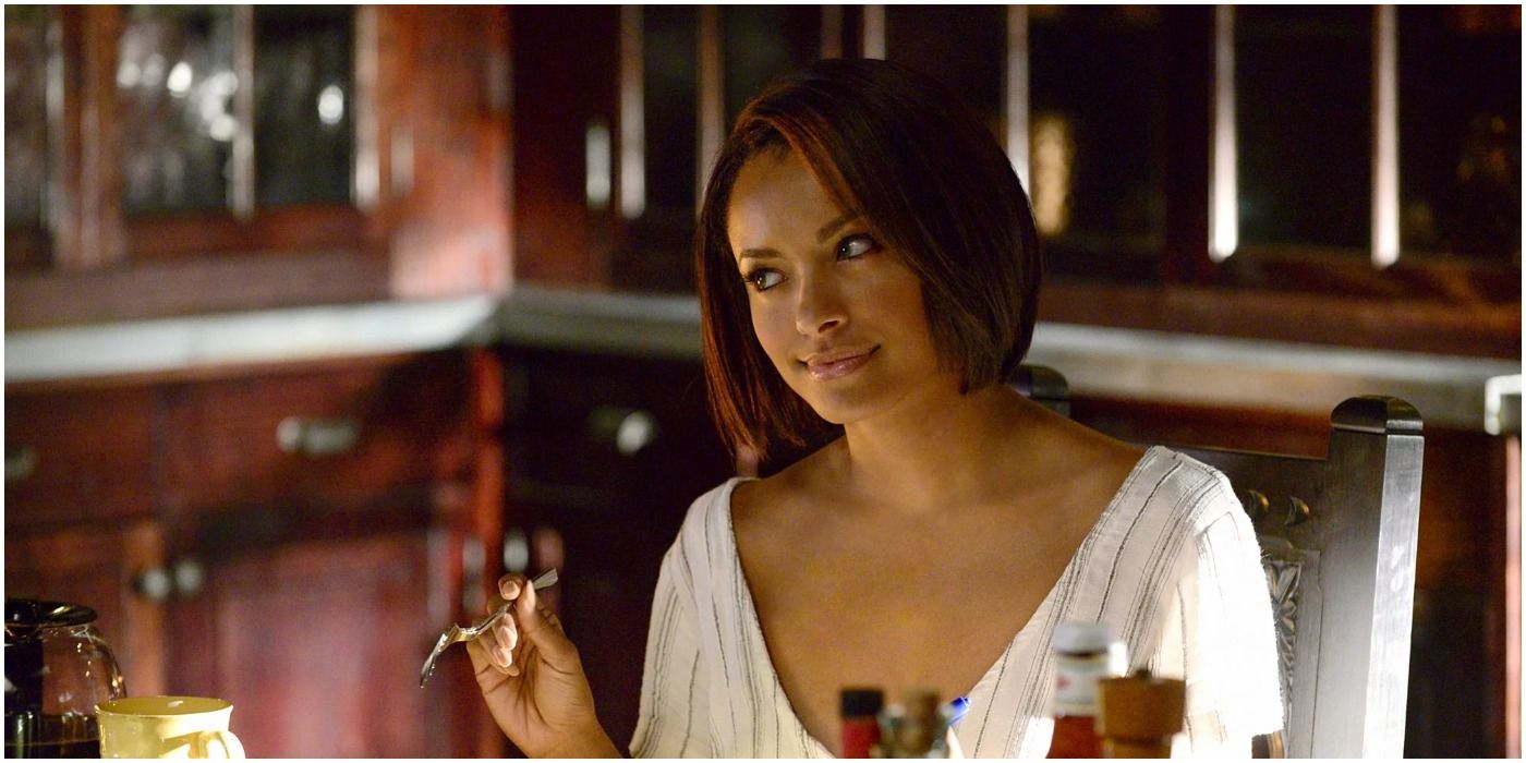 Bonnie Bennett eating at a table in The Vampire Diaries