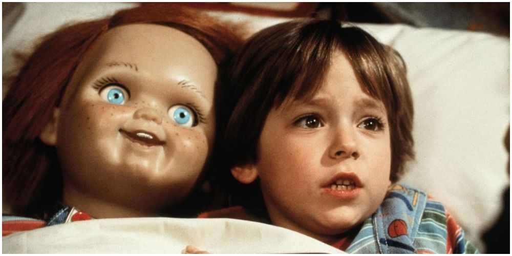 Little Boy And His Doll In Bed