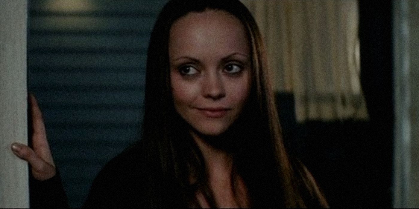 Christina Ricci's Ellie stands in a doorway smiling in Cursed