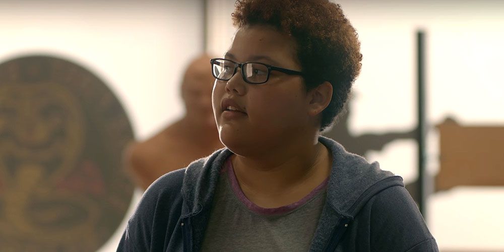 Aisha looks around the dojo in Cobra Kai