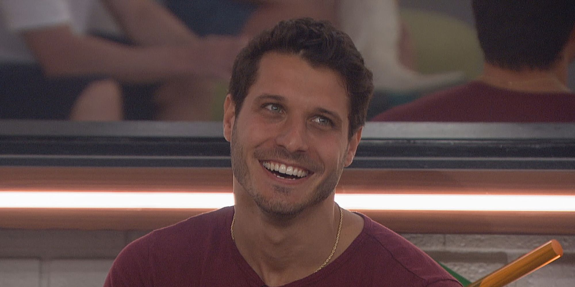 Cody from Big Brother, headed cocked to the side, smiling.