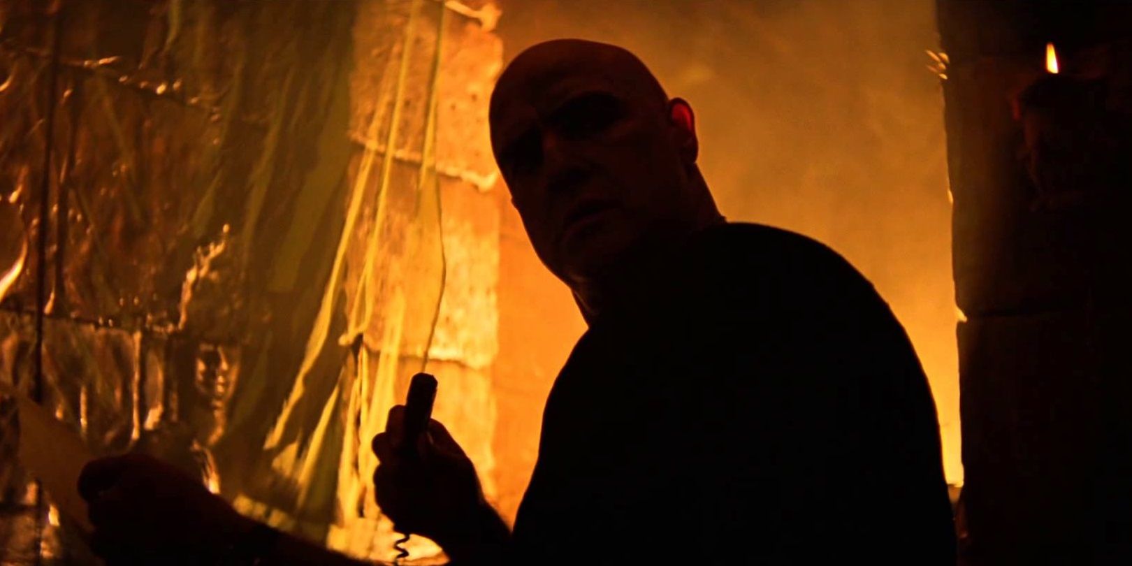 Colonel Kurtz hides in the shadows of his temple in Apocalypse Now