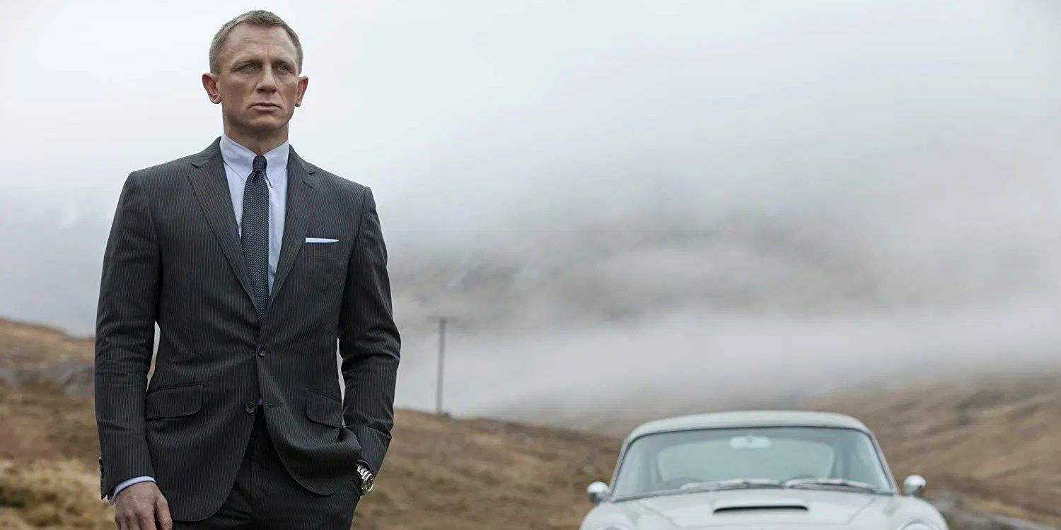 James Bond standing next to a car in a lonely road with a cloudy sky