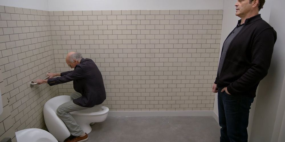 Larry testing out the ladies’ urinal in Curb Your Enthusiasm