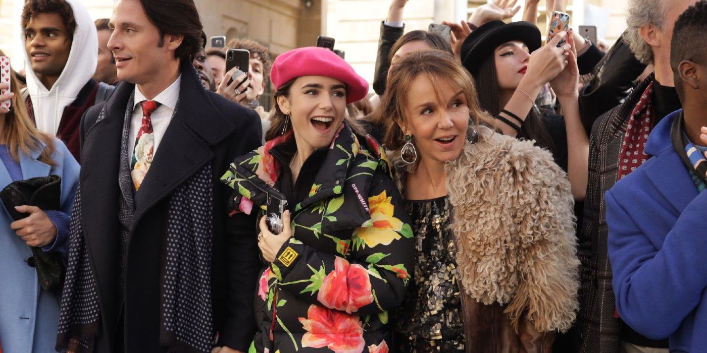 Emily and Sylvie laughing at a fashion event in Emily in Paris