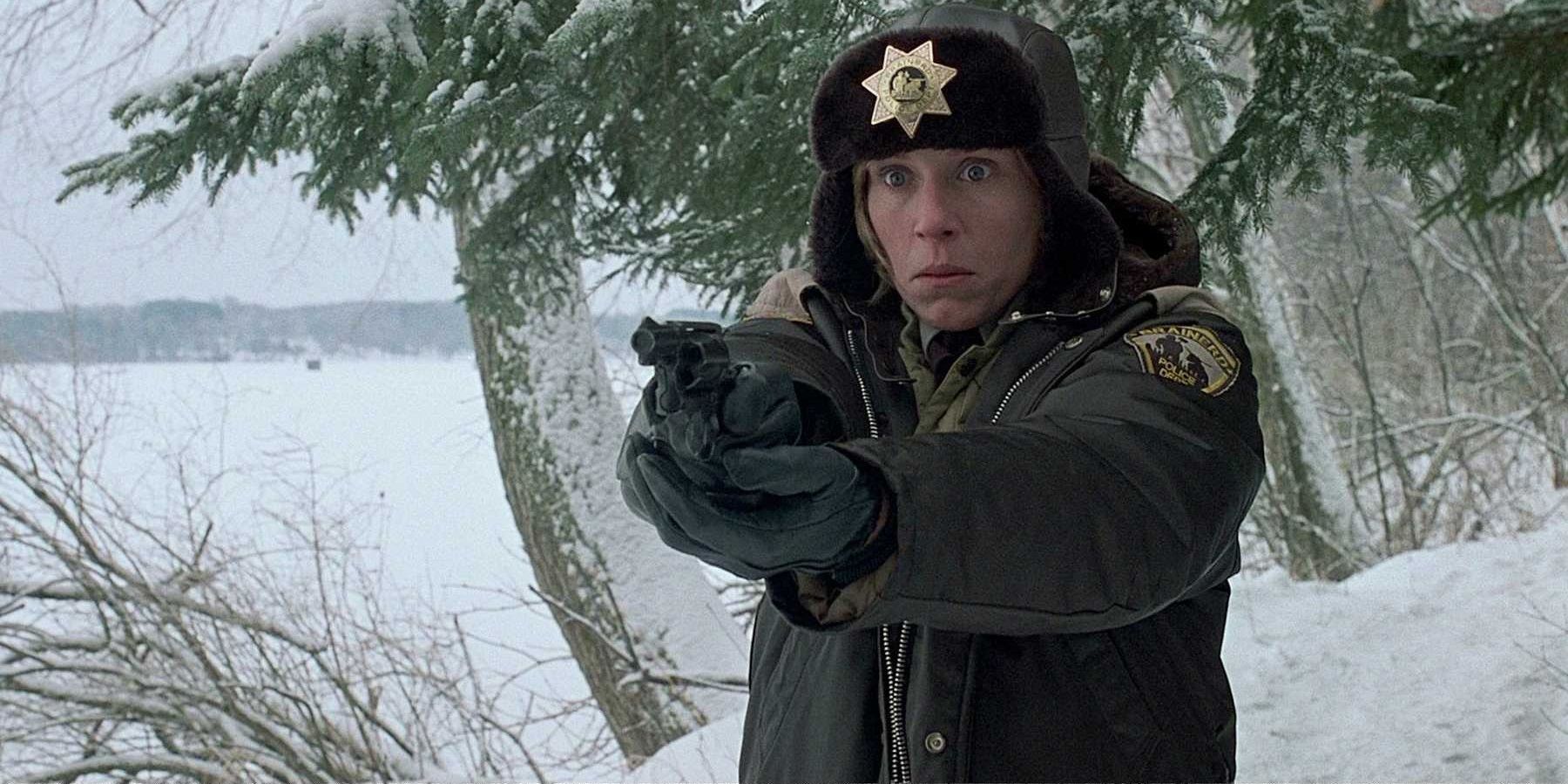 Frances McDormand holding a gun in the snow in Fargo