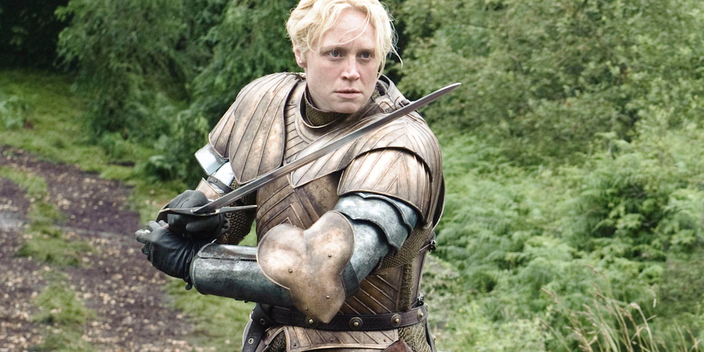 Gwendoline Christie as Brienne Of Tarth in Game of Thrones wielding a sword and wearing armour