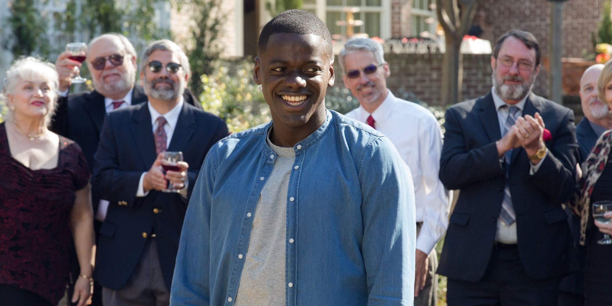 A screenshot of Chris Washington being surrounded by white houseguests in Get Out