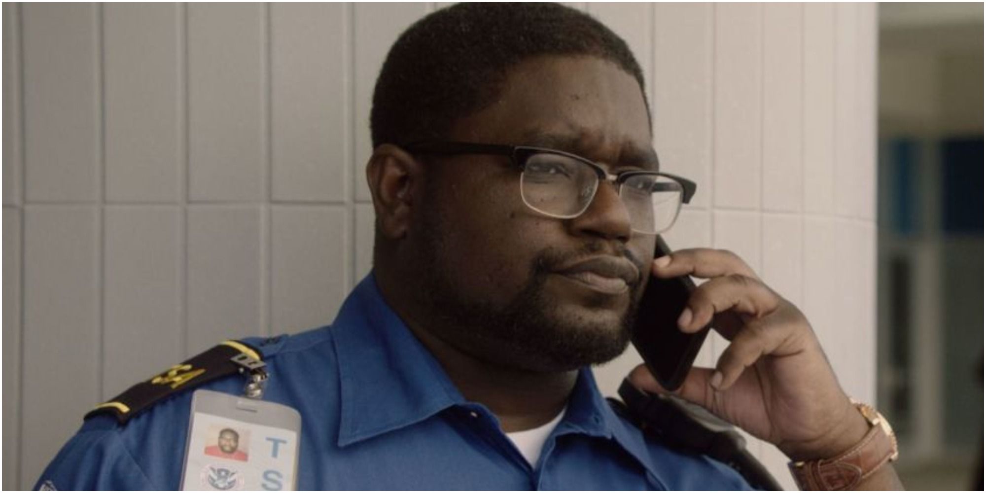 A screenshot of Rod (Lil Rel Howery) at work as TSA from Get Out