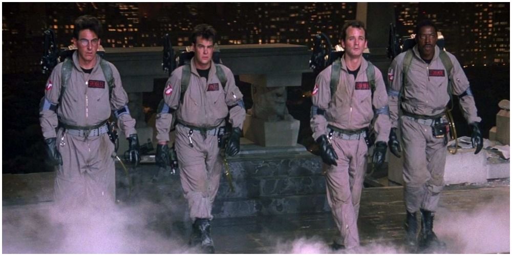 Four Men In Jumpsuits Walking Away