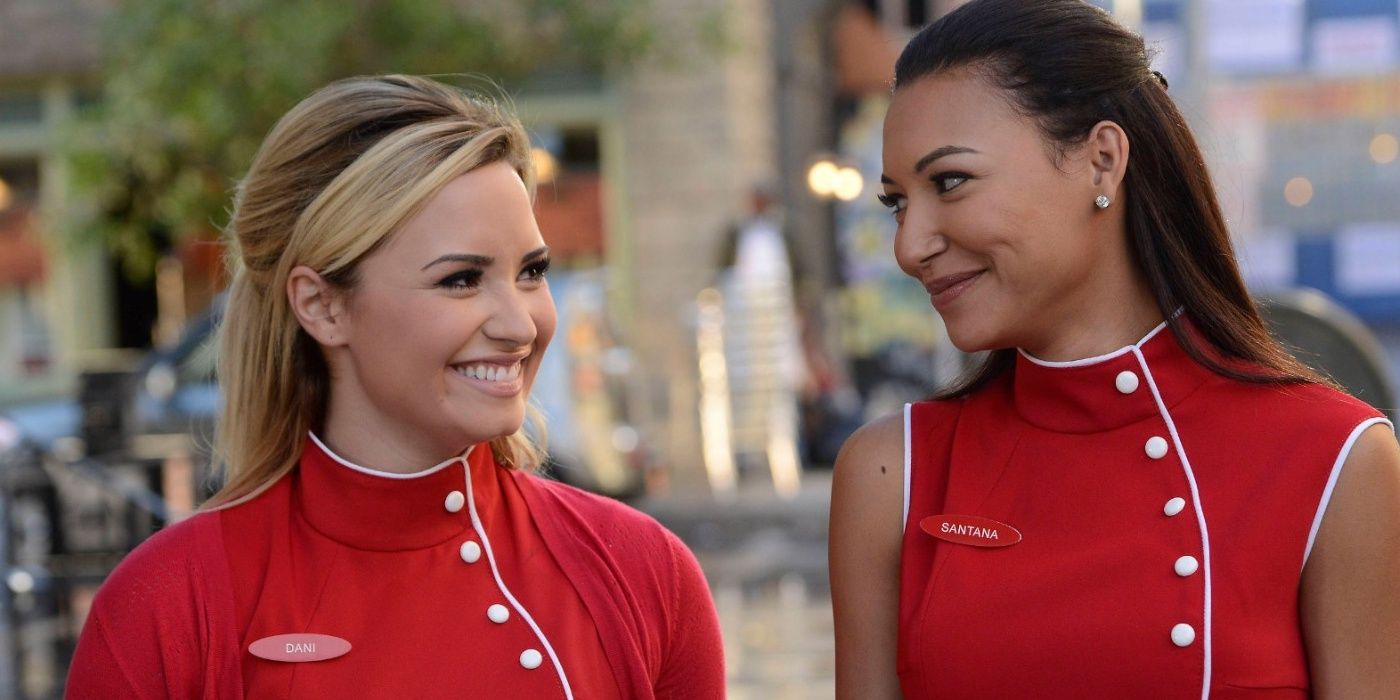 Dani and Santana smiling at each other in Glee.
