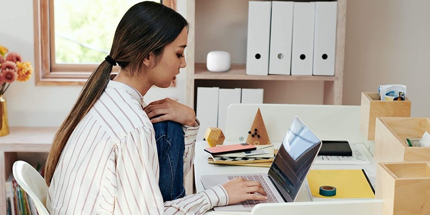 Woman using a laptop on Google Nest Wifi