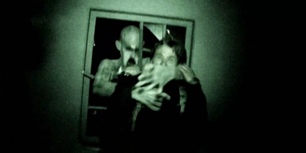 A character being grabbed by a ghost in Grave Encounters