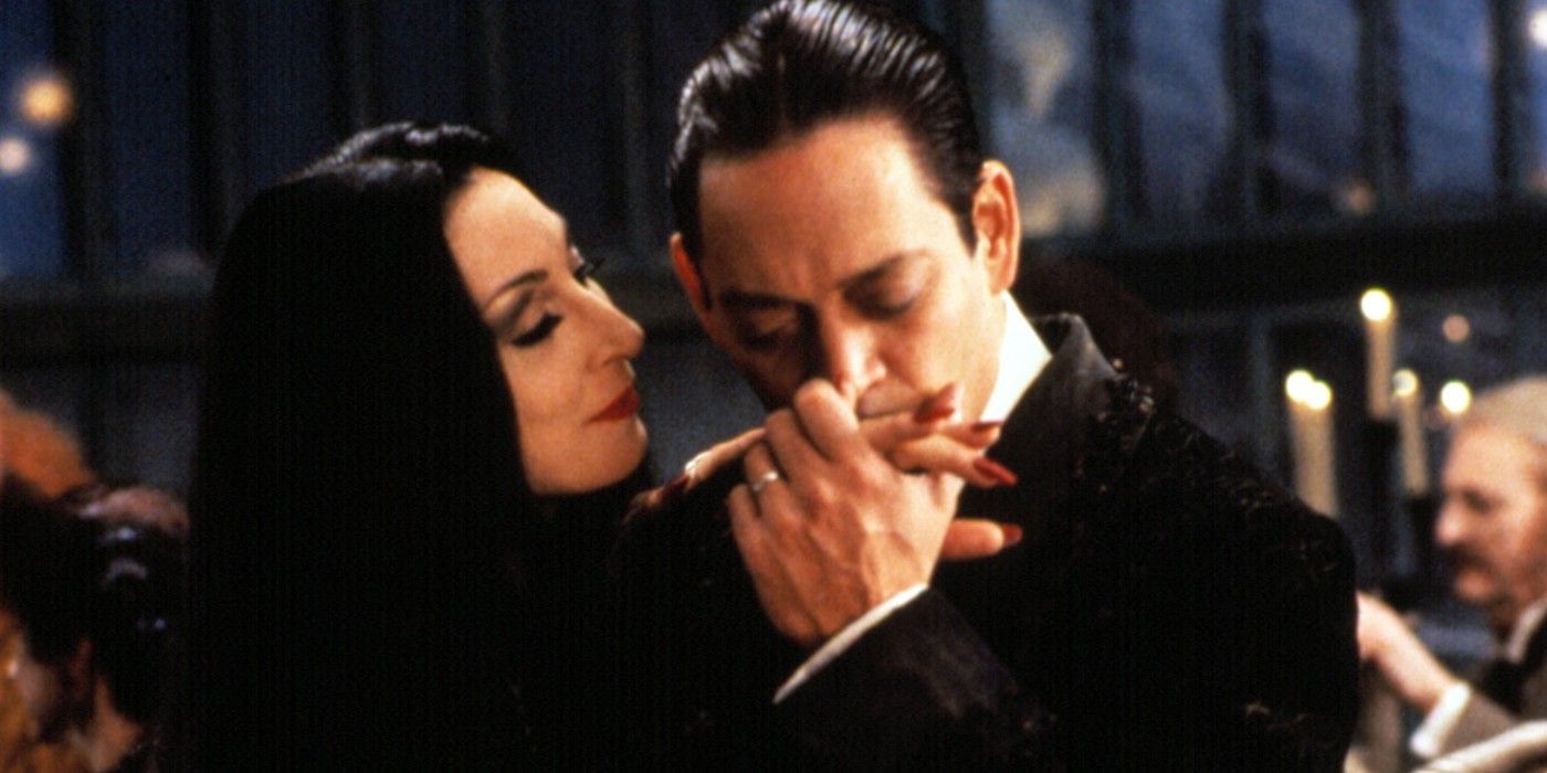 Gomez kissing Morticia Addams hand.