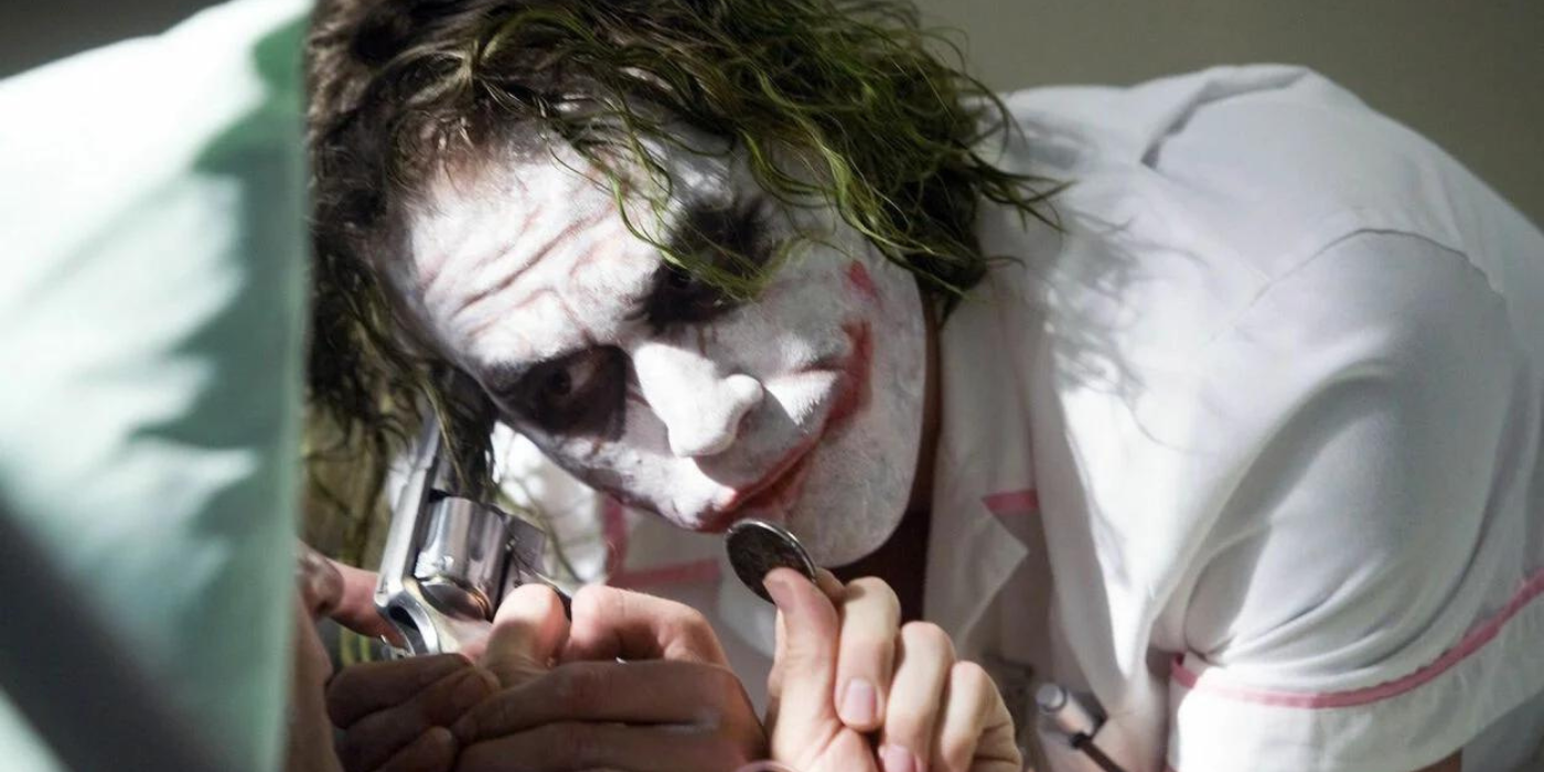 Heath Ledger's Joker leaning in close to Two-Face in the hospital in The Dark Knight