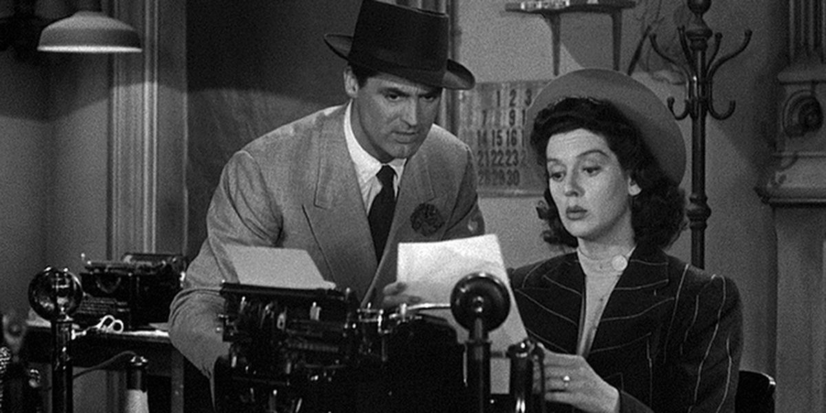 Cary Grant and Rosalind Russell over a typewriter in His Girl Friday