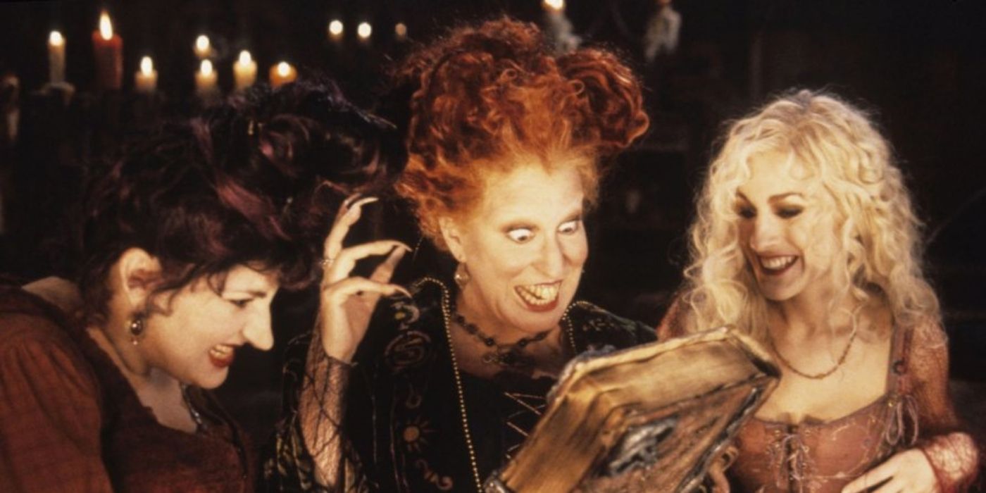 Mary, Sarah, and Winnie looking at the spell book on Hocus Pocus
