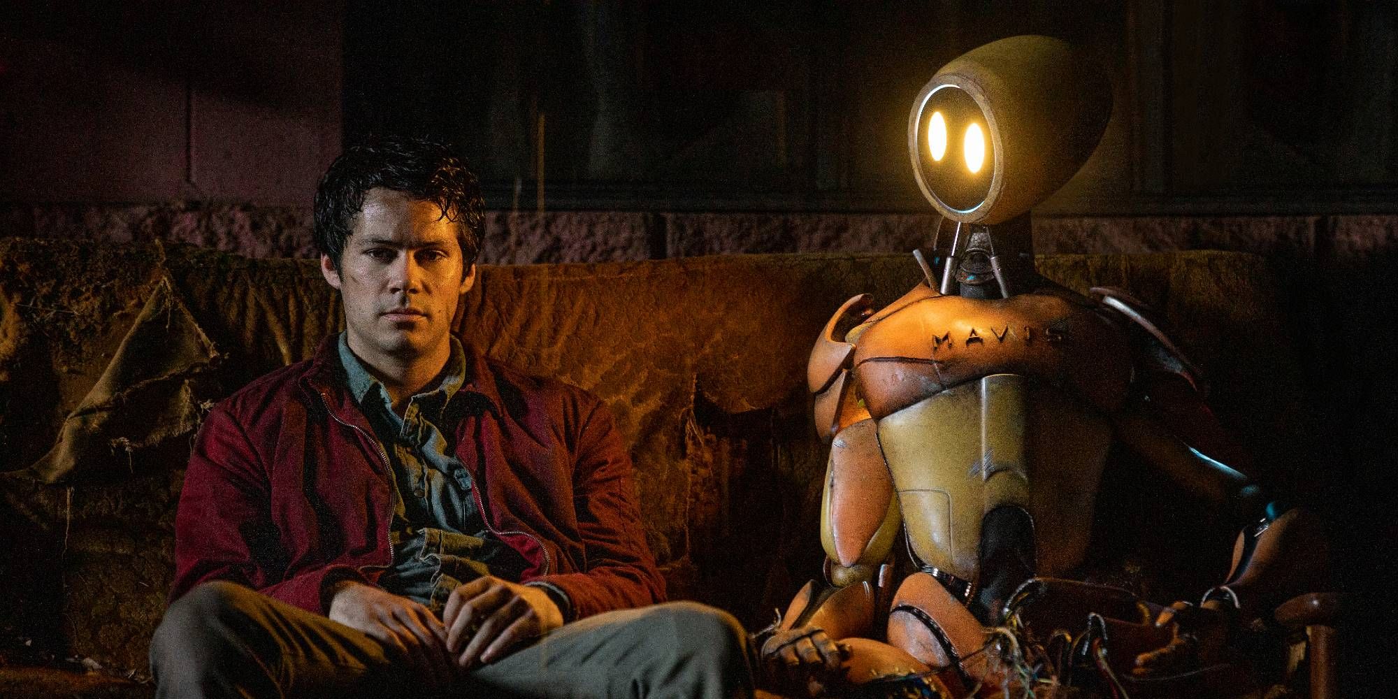 Joel sits with a MAVIS robot in Love And Monsters