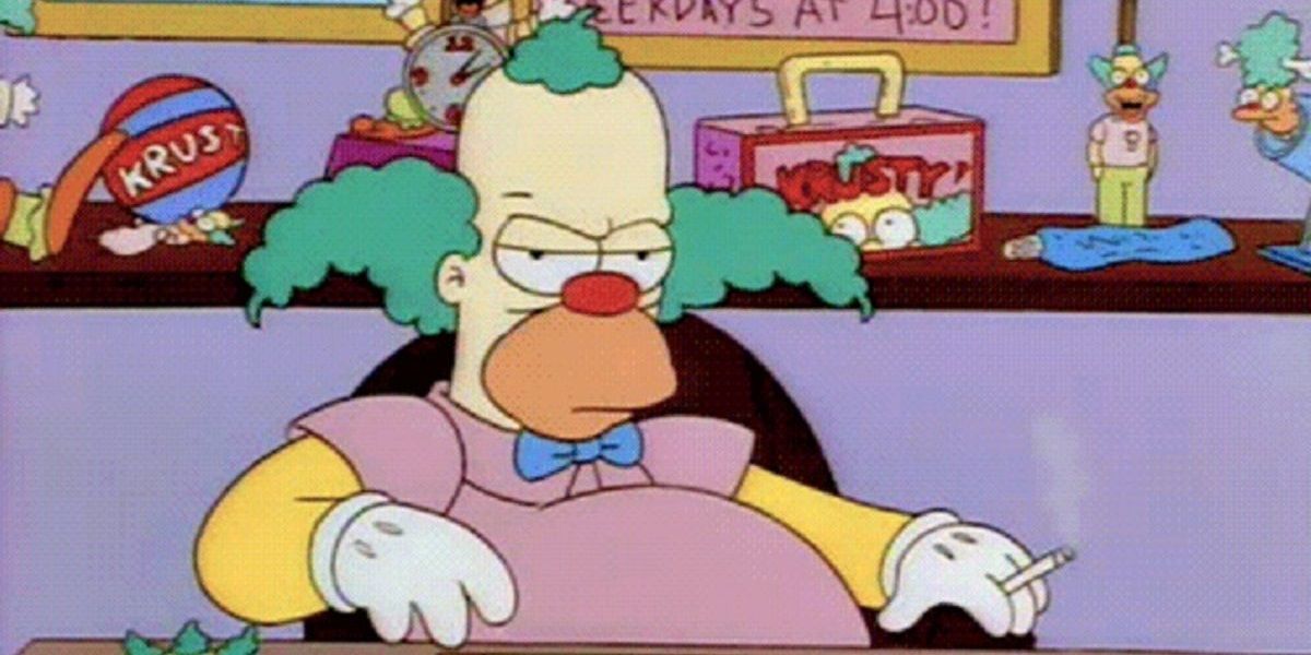 Krusty the Clown sits in a chair while smoking from The Simpsons 
