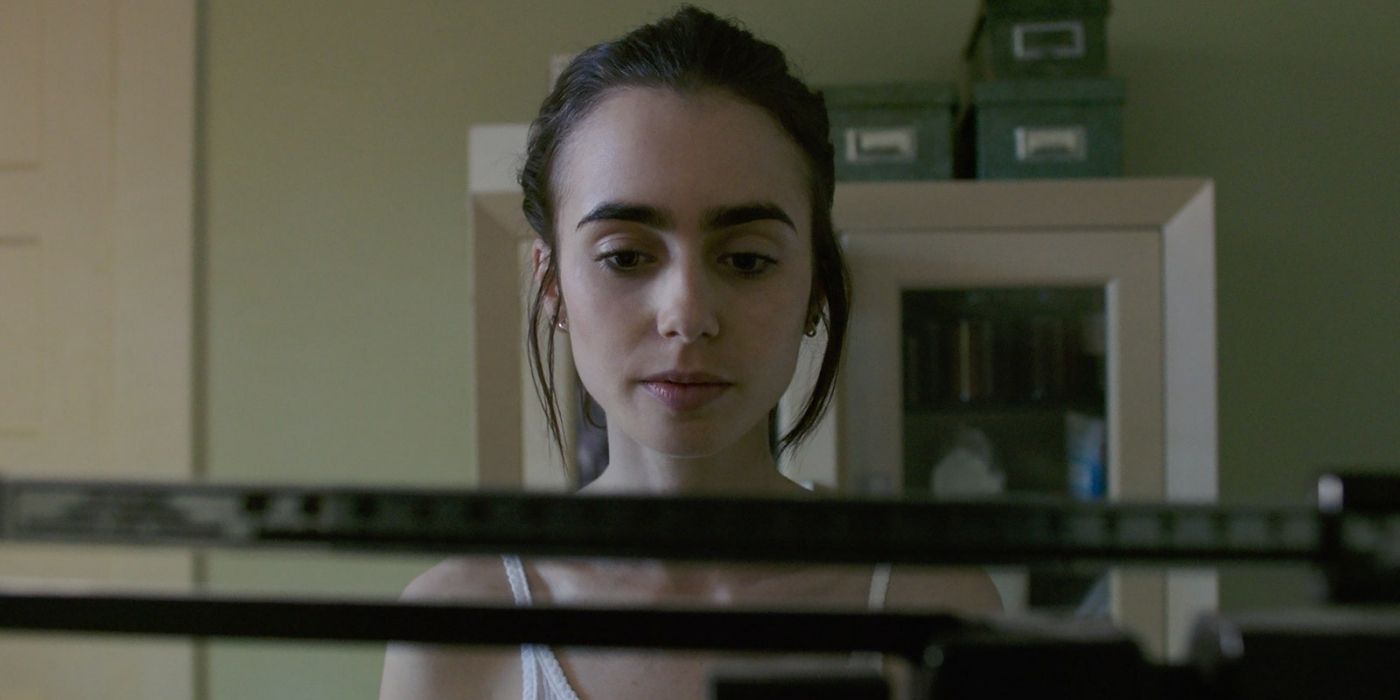 Lily Collins looking at a scale in To The Bone.