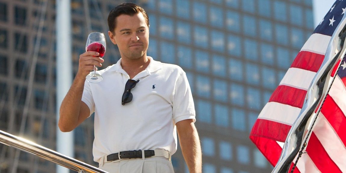 Jordan Belfort toasting and smiling in The Wolf of Wall Street