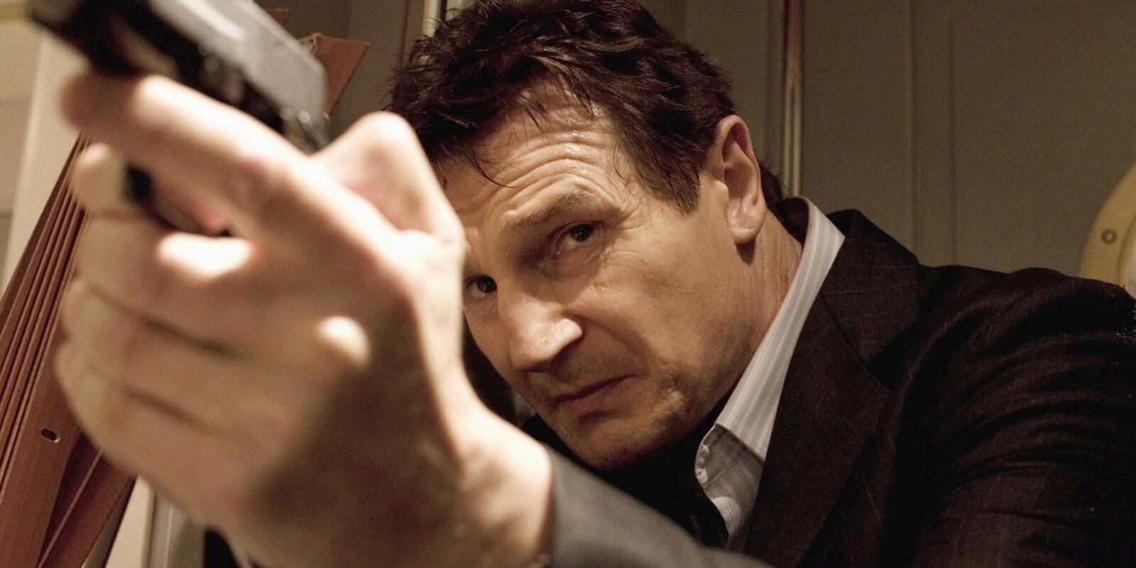 Liam Neeson holding a gun in Taken