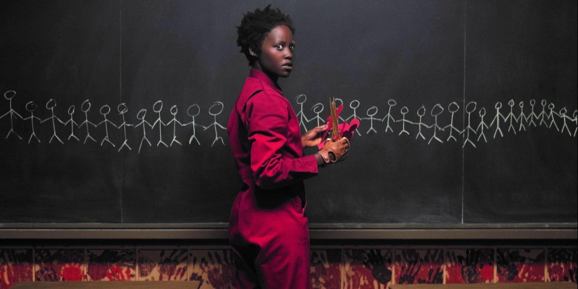 Red standing in front of a blackboard in Us