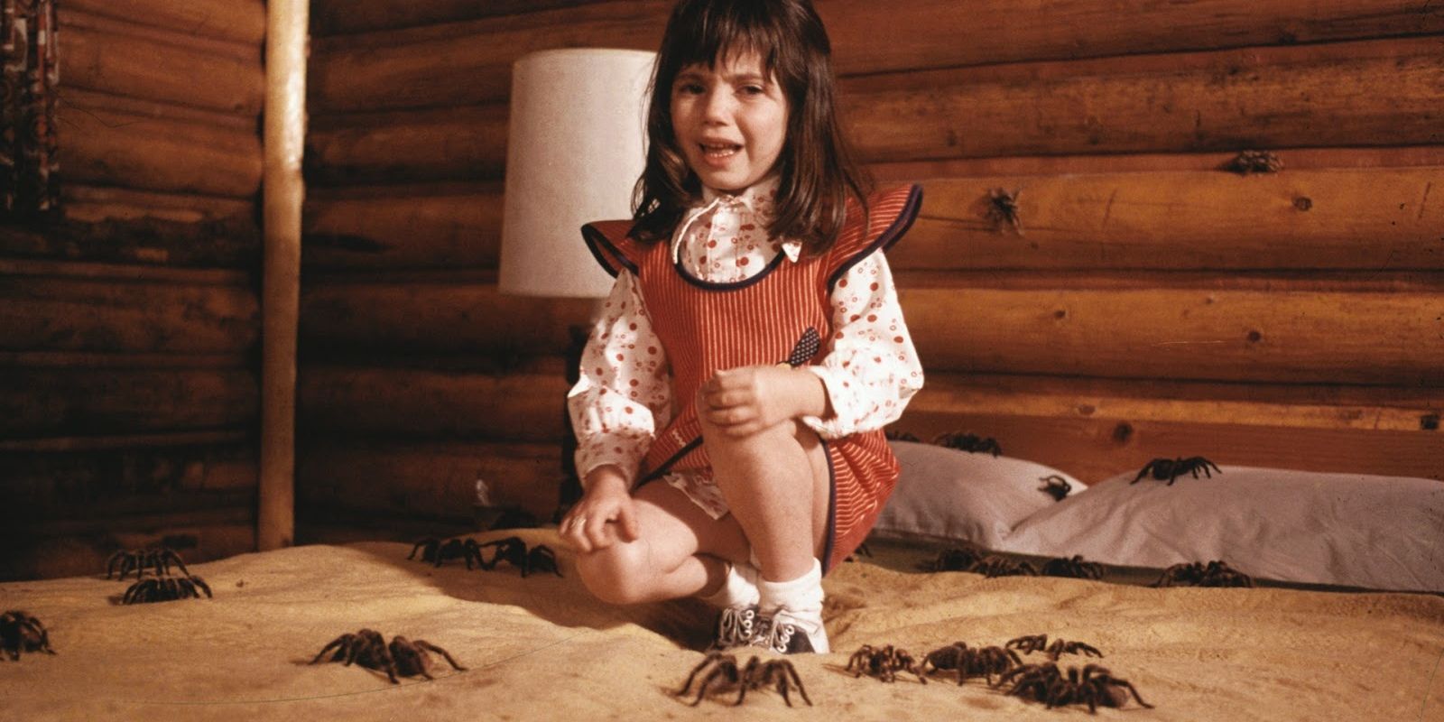 little girl in a bed of spiders