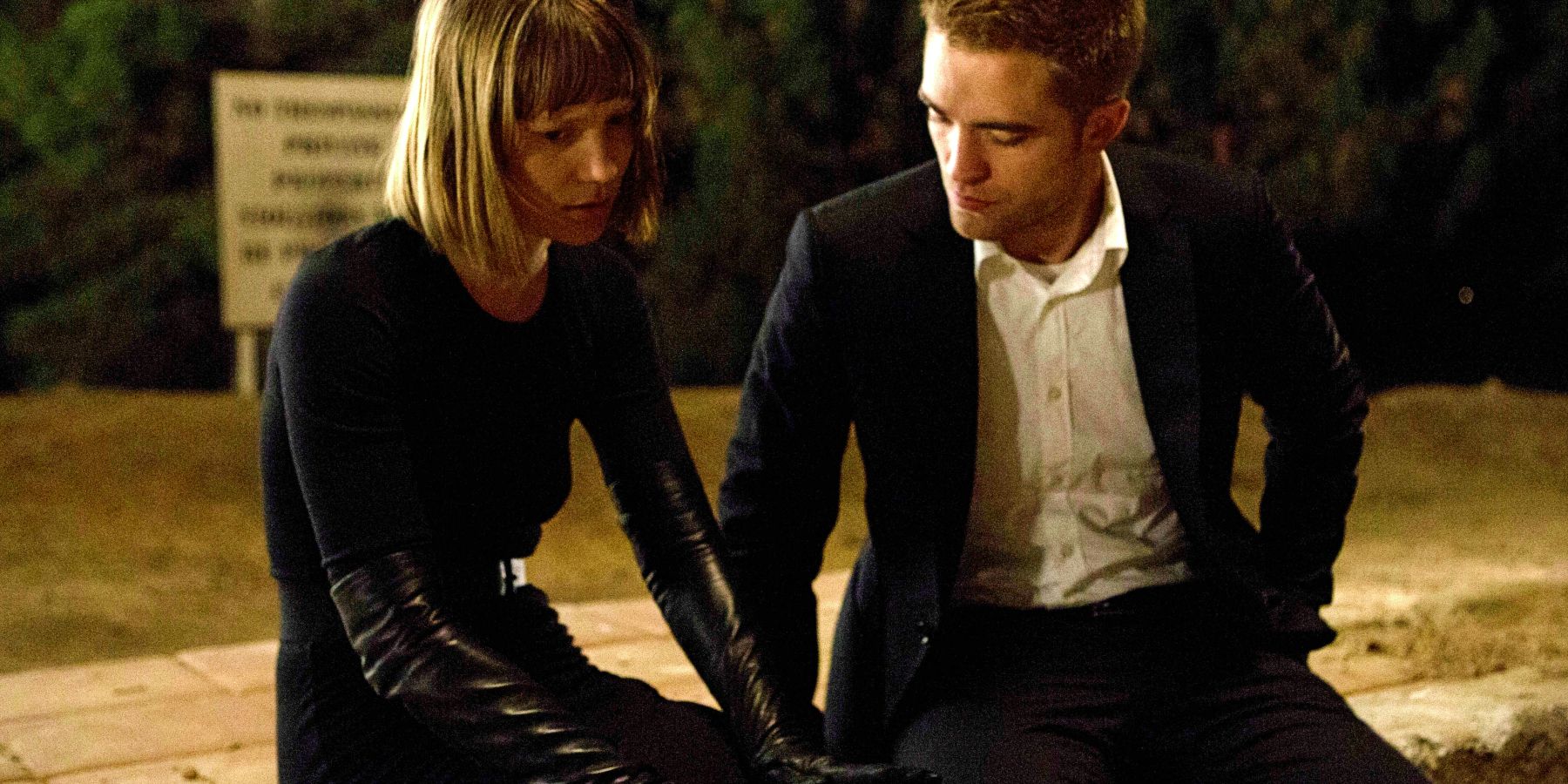 Robert Pattinson and Mia Wasikowska looking sad in Maps To The Stars 