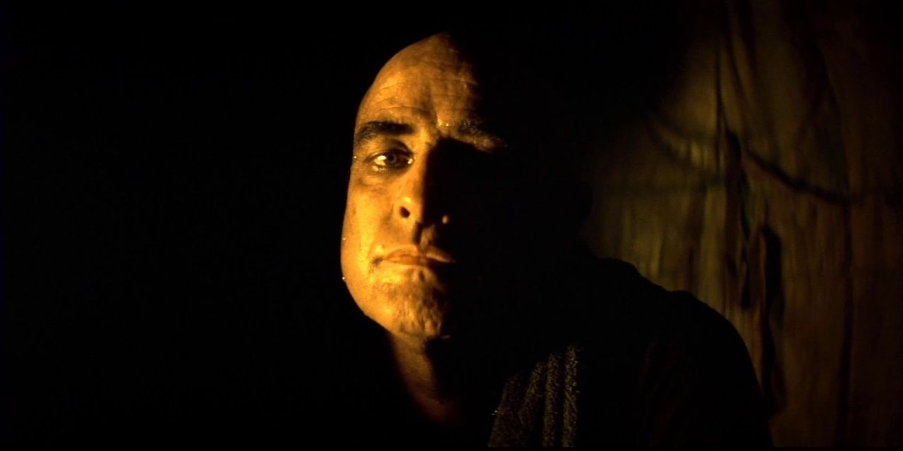 Marlon Brando standing in the shadows in Apocalypse Now