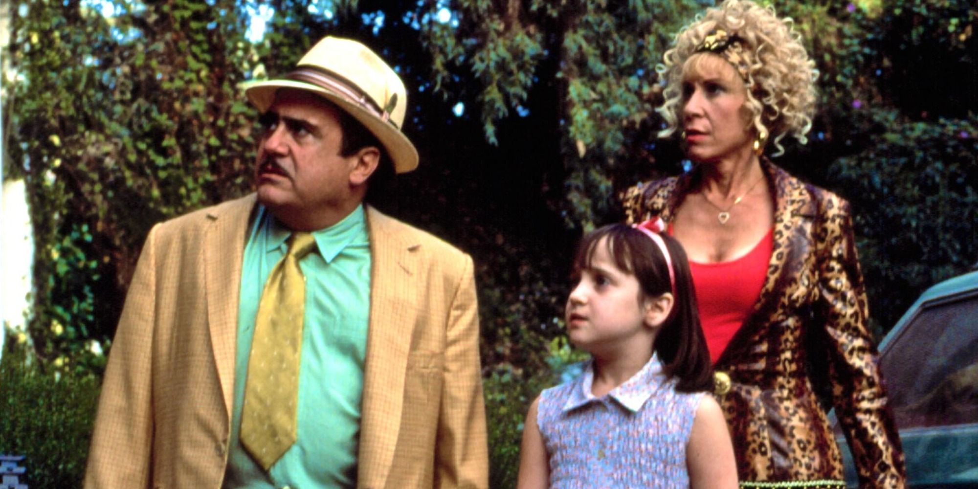 A screenshot of Mara Wilson's Matilda and her parents Mr. and Mrs. Wormwood confronting Ms. Honey in Matilda (1996)
