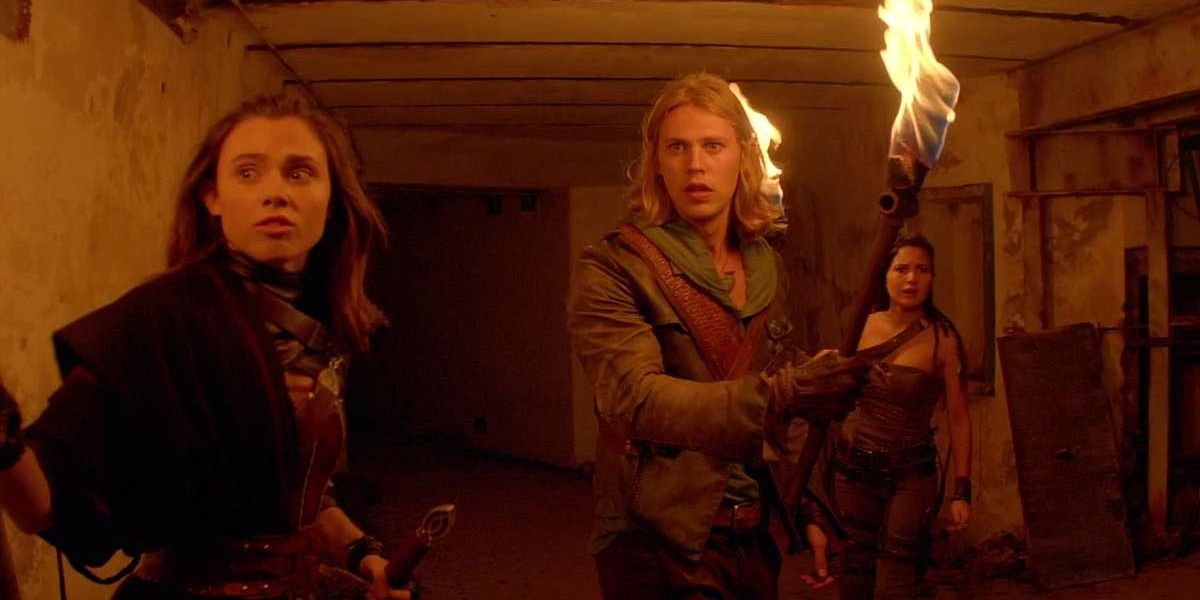 Amberle Elessedil (Poppy Drayton), Wil Ohmsford (Austin Butler), and Eretria (Ivana Baquero) holding torches in The Shannara Chronicles