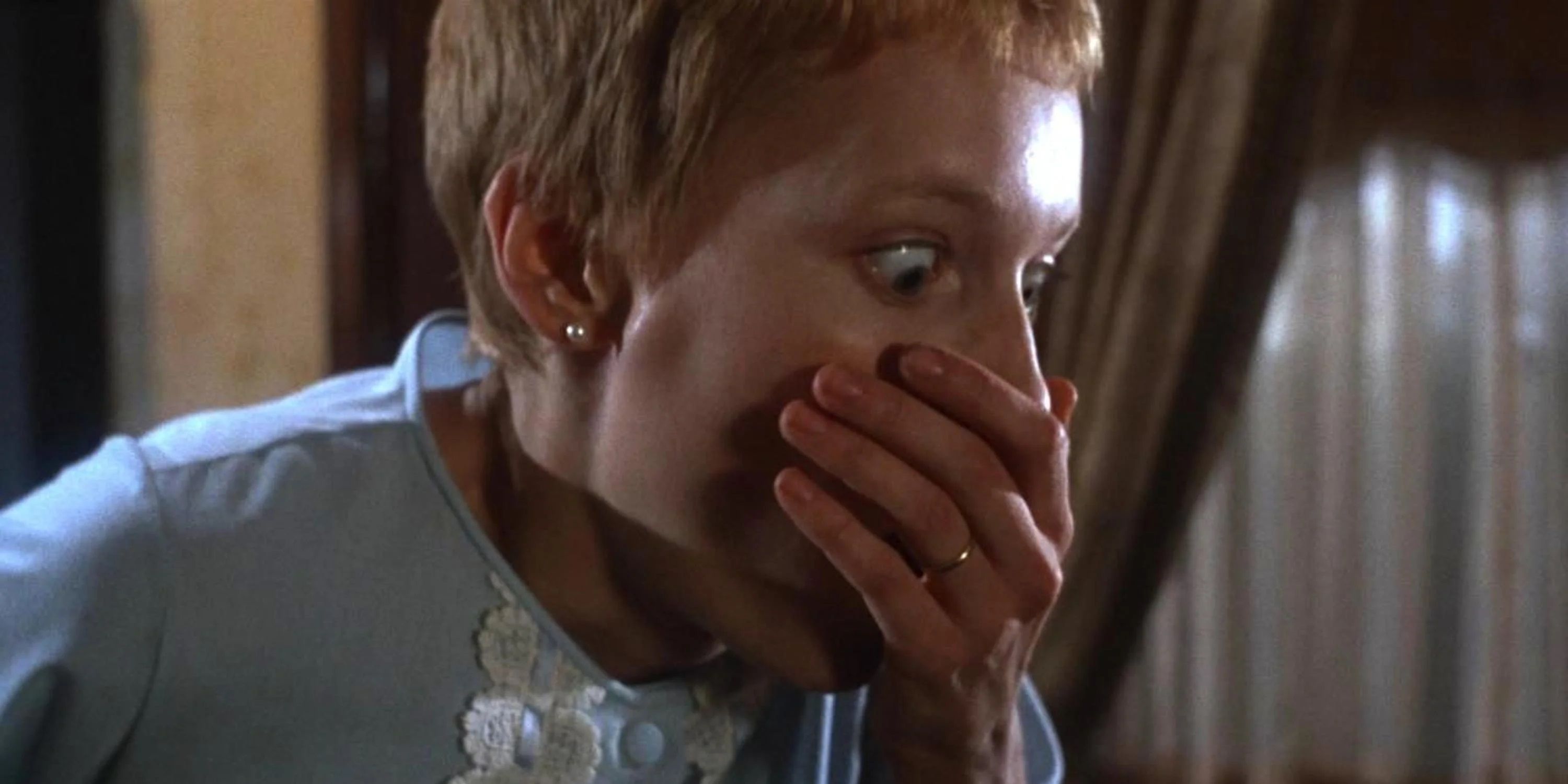 Rosemary covering her mouth in shock in Rosemary's Baby