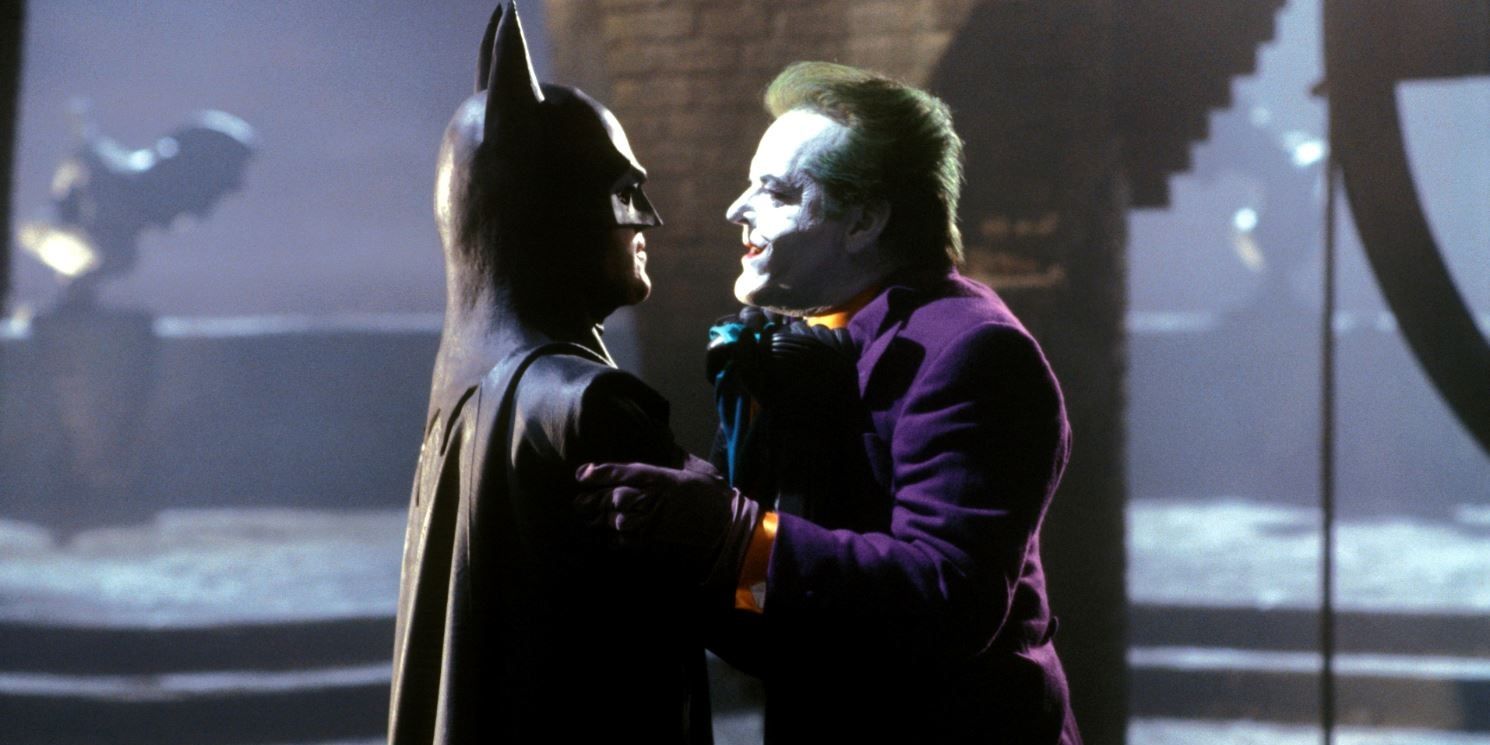 Batman grabs the Joker's collar in Batman