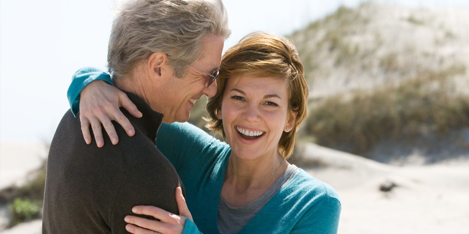 Adrienne and Paul laughing on the beach in Nights in Rodanthe